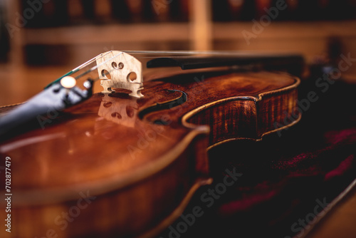 close up shot of a viola laying on velvet at a musical instrument shop