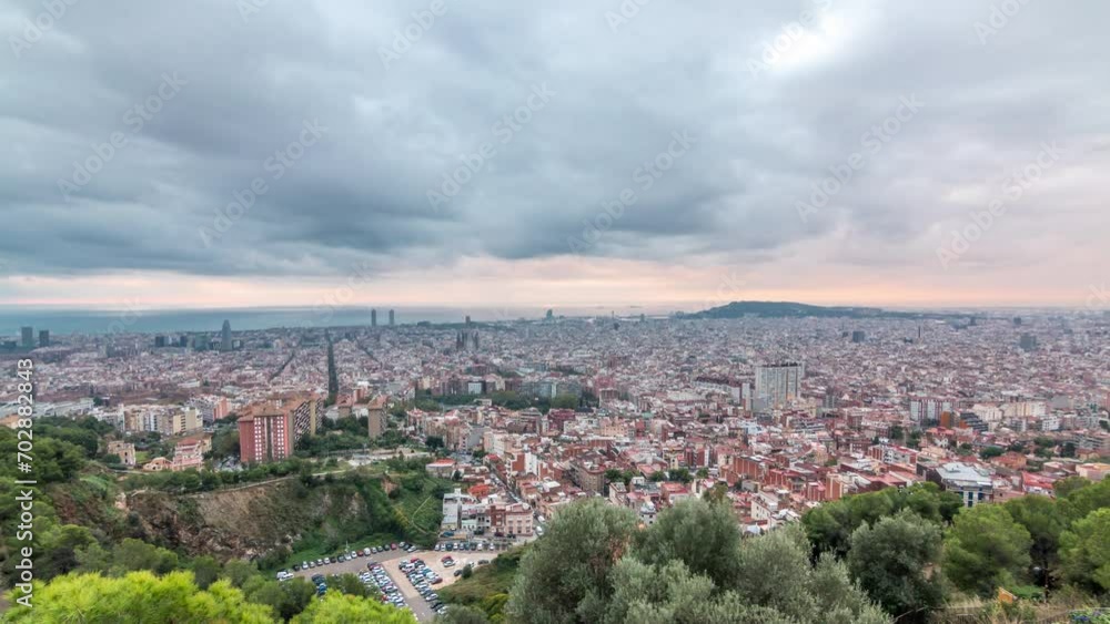 Barcelona's Dawn Tapestry: Sunrise Timelapse Panorama from the Bunkers of Carmel in Spain. Aerial Top View from the Hill, Rays of Light Pierce Through Clouds, Painting the Sky in a Spectrum of Colors Barcelona's Dawn Tapestry: Sunrise Timelapse Panorama from the Bunkers of Carmel in Spain. Aerial Top View from the Hill, Rays of Light Pierce Through Clouds, Painting the Sky in a Spectrum of Colors