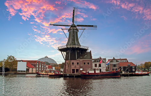 Medieval windmill in Haarlem citycenter in the Netherlands at sunset photo