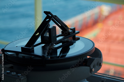 Closeup view of azimuth circle fitted in the bridge of a merchant ship at sea photo