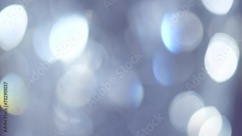 Abstract blurred bokeh glowing background. Crystal Holiday bokeh backdrop. Blinking shining reflection. Diamond light refraction and rays. Decoration. Wallpaper. Slow motion photo