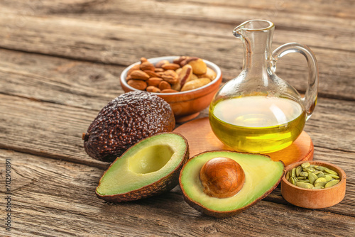 Healthy Fat avocado oil nuts on a wooden background. top view, omega 3, Vegan food