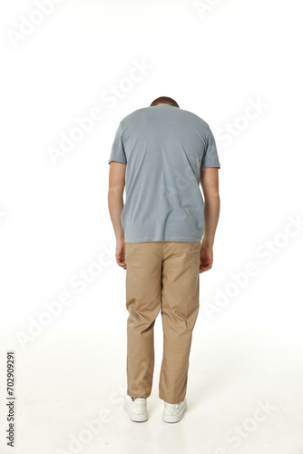 young man on white background, rear view