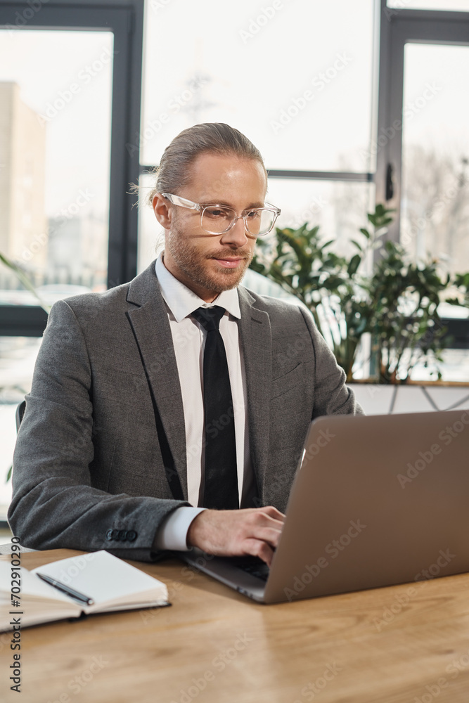 concentrated entrepreneur in eyeglasses and formal wear working on laptop in modern office space concentrated entrepreneur in eyeglasses and formal wear working on laptop in modern office space