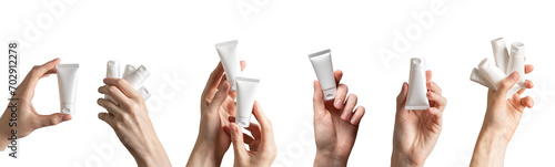 Hand holding cream tubes mockups, beauty product packages, cosmetic packs isolated on white, set