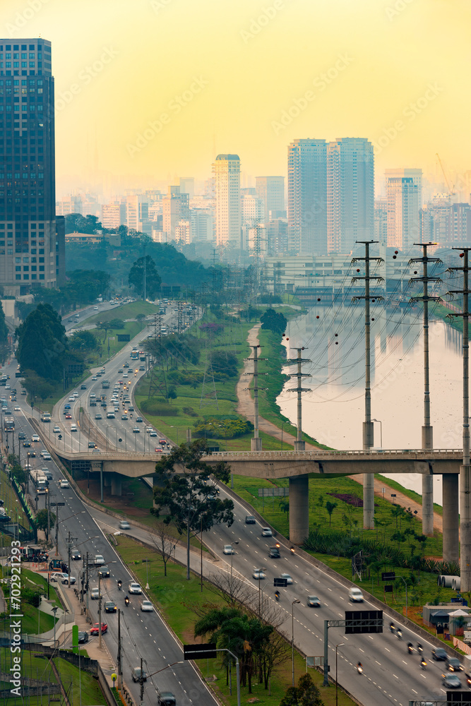 Traffic on Avenue Marginal Pinheiros and city skyline at sunset, Sao Paulo, Brazil