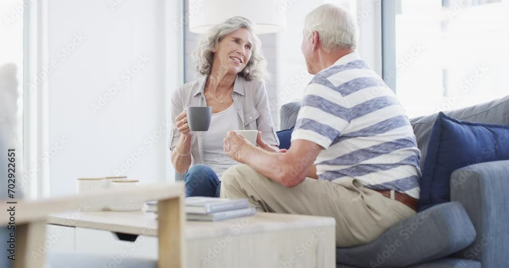 Love, relax and senior couple on a sofa with coffee break conversation and bonding, free or chilling at home. Happy, support and old people in living room with communication, tea and enjoy retirement Love, relax and senior couple on a sofa with coffee break conversation and bonding, free or chilling at home. Happy, support and old people in living room with communication, tea and enjoy retirement