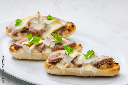 baguette baked with meat, onion and cheese