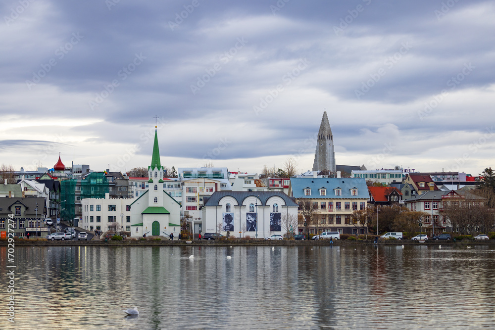 overlooking Tjörnin’s Pond, view of old town Reykjavik, Iceland; spire of Hallgrimskirkja Church in the background