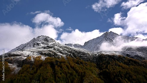 Landscape of the mountains, sky and forest in autumn. Snowcapped mountain. Gouille, Evolene, Switzerland. photo