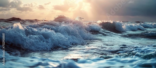 Coastline with waves during sunset. Waves during storm. Wave reaches beach. Splashing ocean waves. Rising storm near seaside. photo