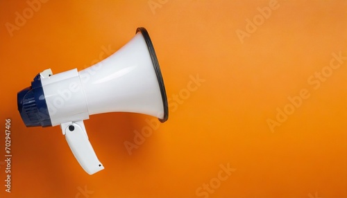 white megaphone or bullhorn floating over orange background business announcement or communication concept with copy space