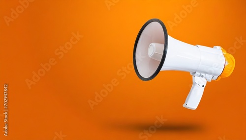 white megaphone or bullhorn floating over orange background business announcement or communication concept with copy space photo