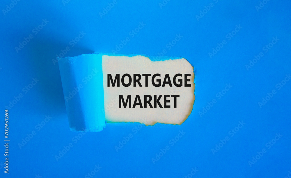 Mortgage market symbol. Concept words Mortgage market on beautiful white paper. Beautiful blue paper background. Business mortgage market concept. Copy space. Mortgage market symbol. Concept words Mortgage market on beautiful white paper. Beautiful blue paper background. Business mortgage market concept. Copy space.