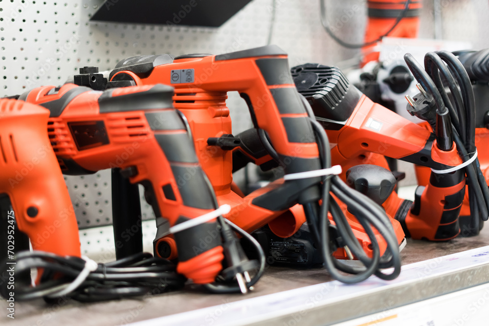 Power tools, drills and hammers of various manufacturers are sold in a hardware store. Power tools, drills and hammers of various manufacturers are sold in a hardware store.