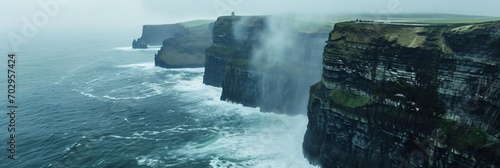 Foggy Cliffs of Moher. Majestic landscape with a view of the ocean and stormy weather in Ireland. Cliffs and wild Atlantic ocean from top view. The beauty of Irish nature, Ireland