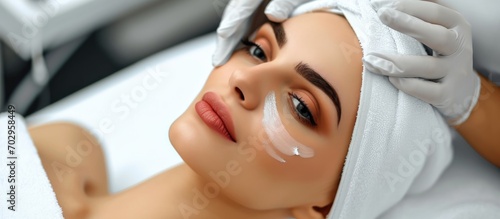 Beautician rejuvenating a woman's skin through facial treatment.