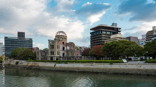 Hiroshima, Japan, zoom out timelapse of sunrise over the Hiroshima Peace Memorial, aka Atomic Bomb Dome, the only structure left standing in the area where the first a-bomb exploded on August 6, 1945. photo