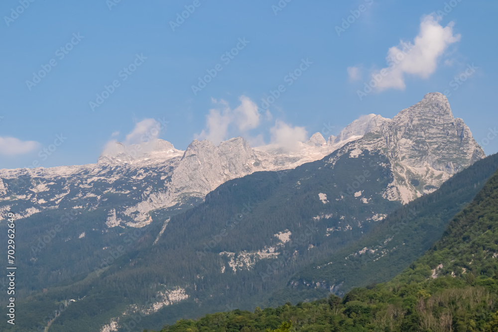 Panoramic view of mount Vrh Jerebceve police and Monte Forato seen from Bovec, Julian Alps, Slovenia Jagged contours of majestic mountain peaks in Soca valley. Wanderlust hiking in wild Slovenian Alps Panoramic view of mount Vrh Jerebceve police and Monte Forato seen from Bovec, Julian Alps, Slovenia Jagged contours of majestic mountain peaks in Soca valley. Wanderlust hiking in wild Slovenian Alps