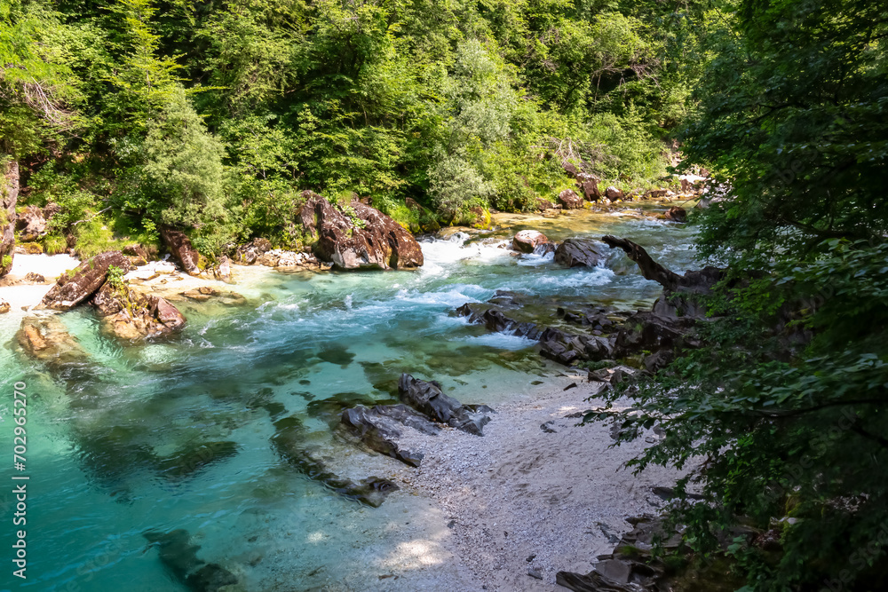 Turquoise creek of Soca river in Bovec, Triglav National Park, Slovenia. Magnificent Soca Valley in breathtaking Julian Alps. Wanderlust in untamed Slovenian Alps. Hiking amidst alpine wilderness Turquoise creek of Soca river in Bovec, Triglav National Park, Slovenia. Magnificent Soca Valley in breathtaking Julian Alps. Wanderlust in untamed Slovenian Alps. Hiking amidst alpine wilderness