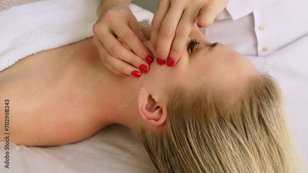Beautician cosmetologist makes lifting neck massage, pinch and roll technique, professional cosmetic procedure in a beauty clinic salon for client. Skin care and cosmetology spa concept. Beautician cosmetologist makes lifting neck massage, pinch and roll technique, professional cosmetic procedure in a beauty clinic salon for client. Skin care and cosmetology spa concept.