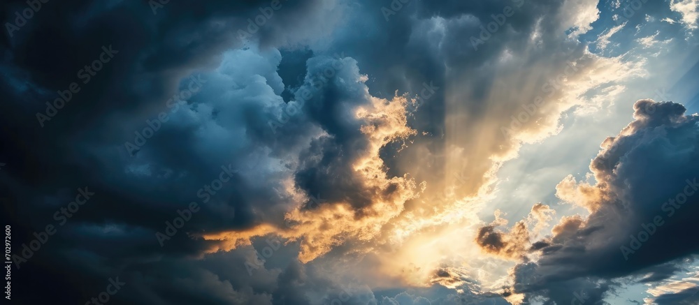 Abstract background of dramatic sky with stormy clouds, contrasting photo with sun peaking through before extreme weather.