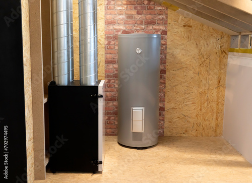 Grey Electric storage water heater with Temperature Display in utility room, brick wooden wall. Hi-Tech Capillary Thermostat. Safe, Environment Friendly system. Smart home, house. Horizontal