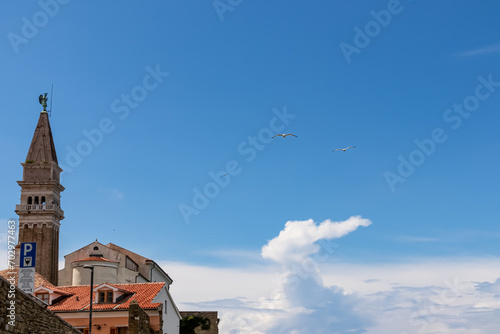 Wallpaper Mural Panoramic view of church Duomo di San Giorgio in coastal town Piran, Slovenian Istria, Slovenia, Europe. Walking path from Fiesa along shimmering waters of the Adriatic Sea. Mediterranean architecture Torontodigital.ca