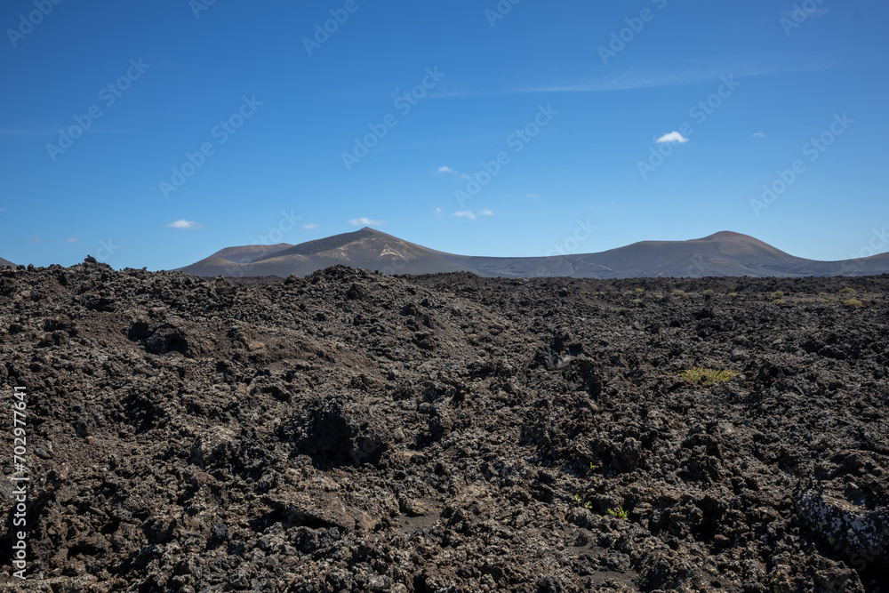 Volcanic soil and a mountain, Lanzarote, Spain Volcanic soil and a mountain, Lanzarote, Spain