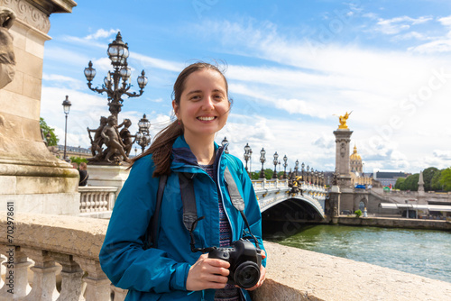 Woman traveler at Bridge Pont Alexandre III in Paris, France