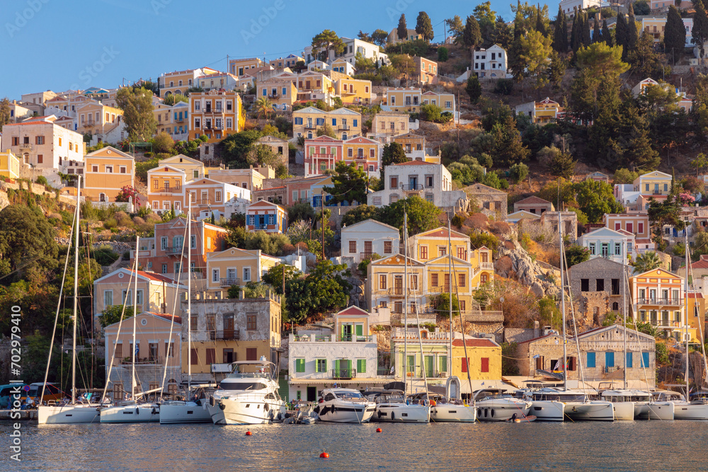 Naklejka premium Multi-colored facades of houses in the village of Symi at sunset.