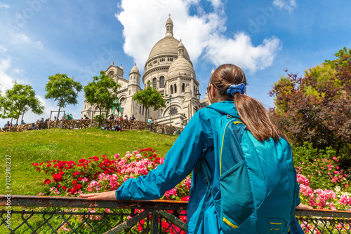 Woman traveler at Basilica of the Sacred Heart at Montmartre hill in Paris, France
