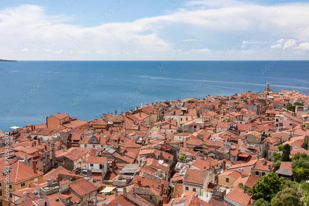 Panoramic aerial view of coastal town Piran, Primorska, Slovenia, Europe. Shimmering azure waters of Adriatic Sea. Tranquil Mediterranean atmosphere. Exploring beauty along slovenian Coast in Istria