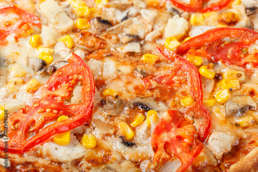 delicious pizza with chicken, mushrooms, cheese, tomatoes and corn on a wooden background delicious pizza with chicken, mushrooms, cheese, tomatoes and corn on a wooden background