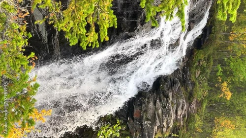 A beautiful waterfall in the autumn mountains beyond the Arctic Circle in the north, in Khibiny, Murmansk region. Panoramic view of a beautiful waterfall in the mountains in autumn, Kola Peninsula 4К photo