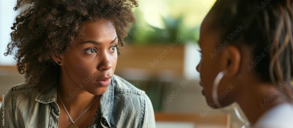 Offering support to a troubled woman confiding in a friend. - obrazy, fototapety, plakaty 