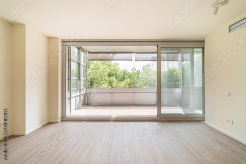 Spacious unfurnished living room with access to large balcony photo