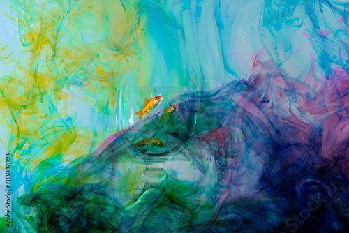 Fototapeta Naklejka Na Ścianę i Meble -  Gold fish in fishbowl surrounded by swirling colors