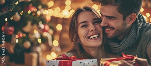 Happy young couple with many gifts. photo