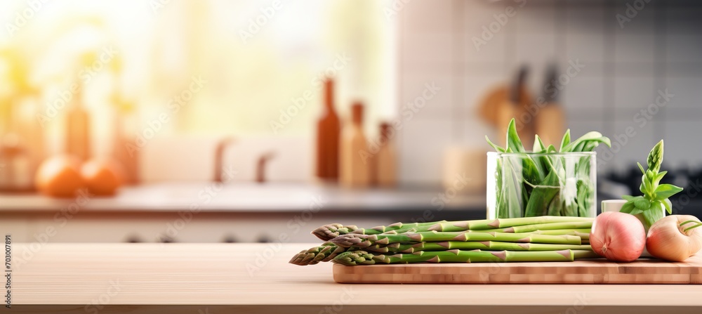Fresh organic asparagus on wooden table, kitchen background, blurred for text placement - obrazy, fototapety, plakaty 