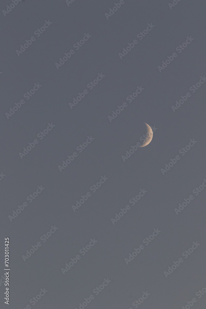 Moon during sunset, Image shows the moon with a slight golden glow as the sun reflects off it Moon during sunset, Image shows the moon with a slight golden glow as the sun reflects off it