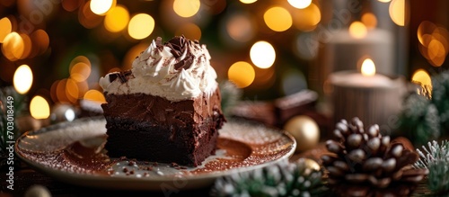 Christmas-themed cocoa hot chocolate coffee brownie cake with whipped cream, against a backdrop of a Christmas tree or city lights, with copy space.