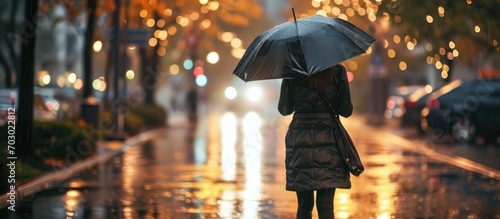 Umbrella-wielding woman in rain boots. photo