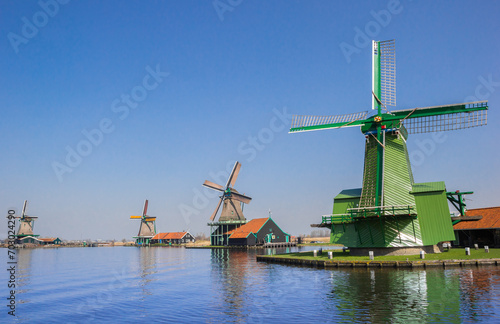 Colorful historic windmills at the Zaan river in Zaanse Schans, Netherlands