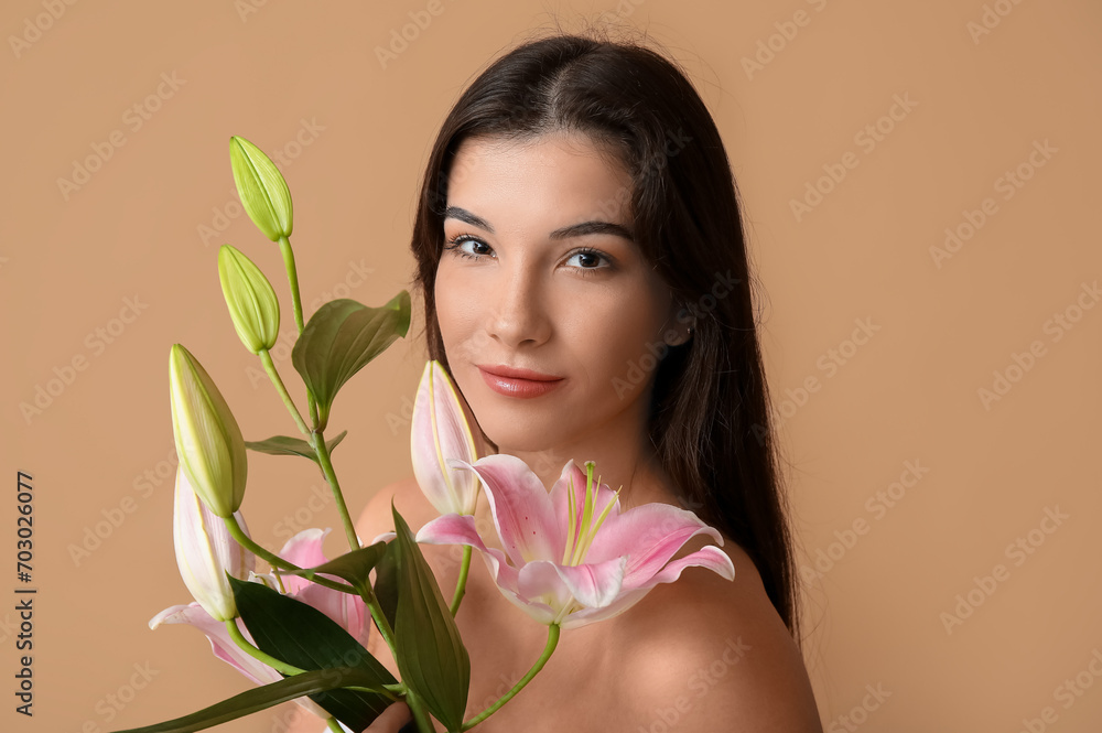 Young woman with lily flowers on color background, closeup