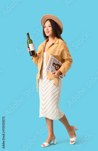 Young Asian woman with bott...