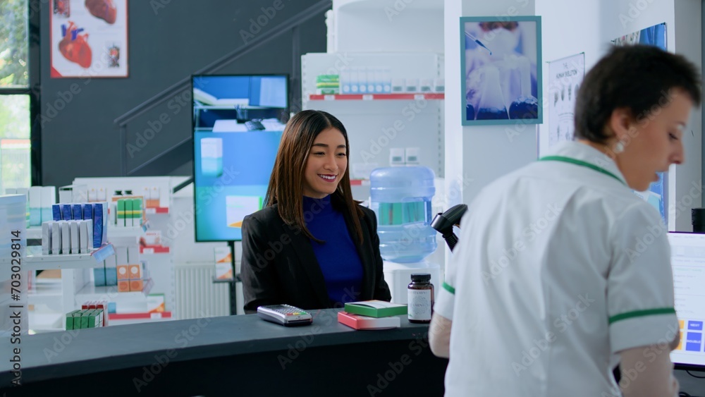 Elderly pharmacy assistant helping asian client pick ideal medicinal products for ailments relievement before reaching drugstore counter. Shopper purchasing supplements and vitamins Elderly pharmacy assistant helping asian client pick ideal medicinal products for ailments relievement before reaching drugstore counter. Shopper purchasing supplements and vitamins