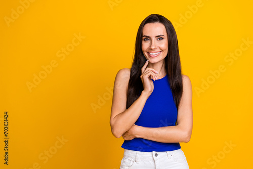 Photo of sweet cute woman wear blue top finger chin empty space isolated yellow color background