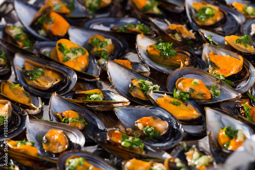 Delicious seafood mussels with parsley on baking sheet