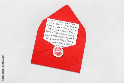 Card with text I LOVE U in red envelope against light background. Valentine's Day celebration